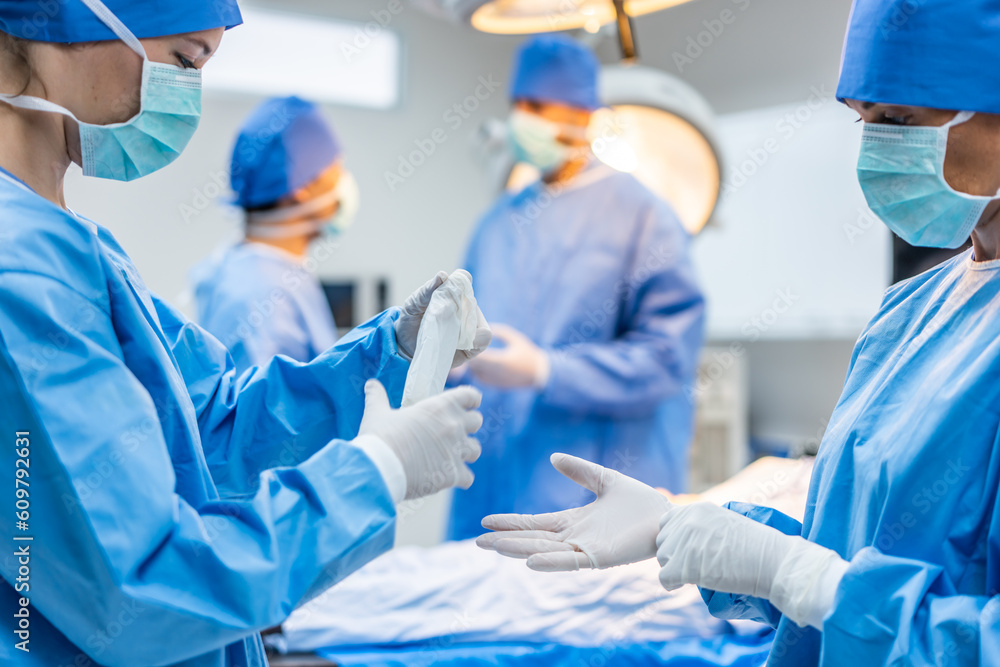 Professional doctors performing surgical operation in operating room. 