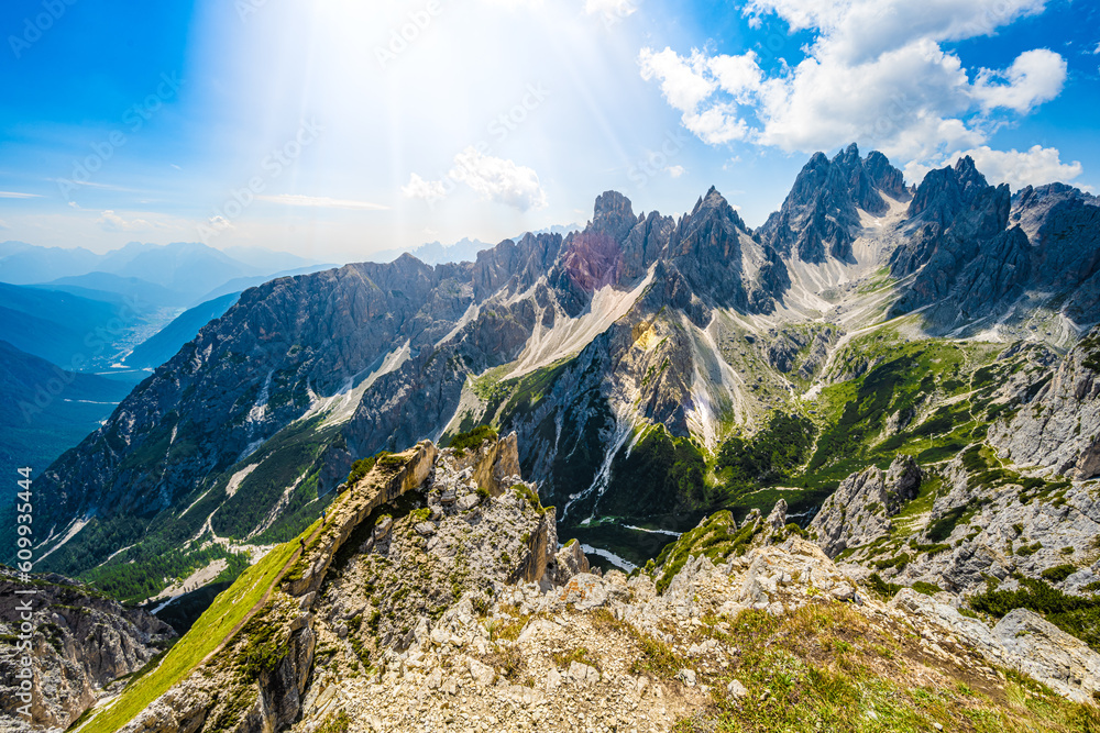 Hiking group enjoys Cadini di Misurina mountain range from epic view point in the morning. Tre Cime,