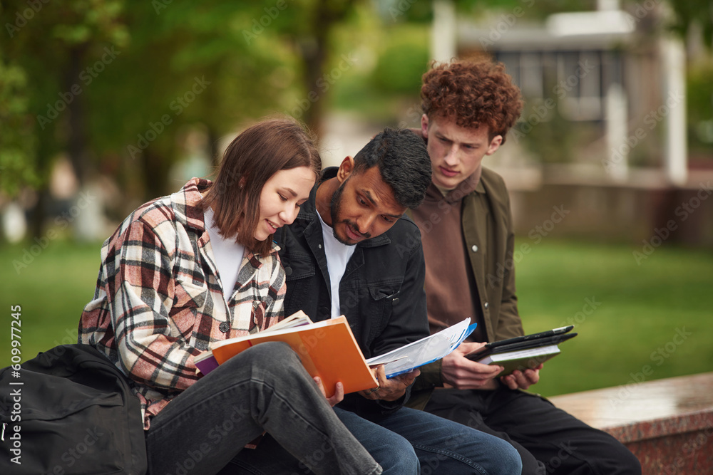 Young students in casual clothes are together outdoors