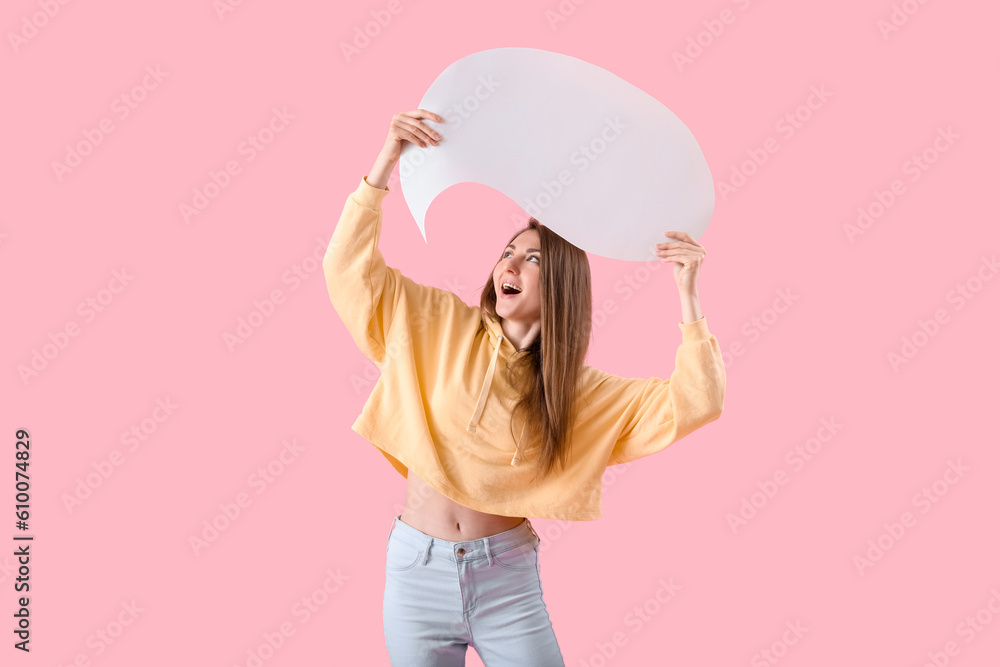 Young woman with blank speech bubble on pink background