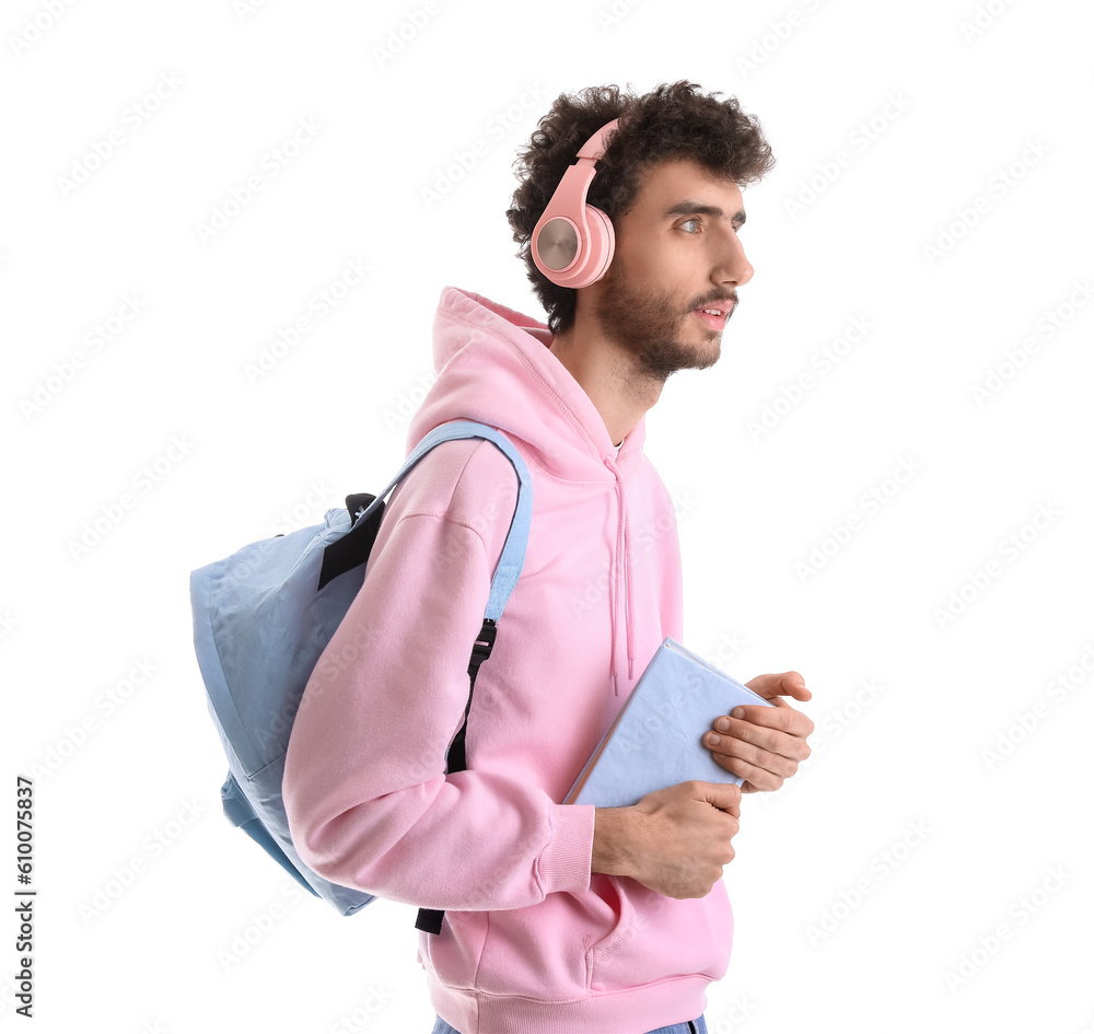 Male student in headphones with book on white background