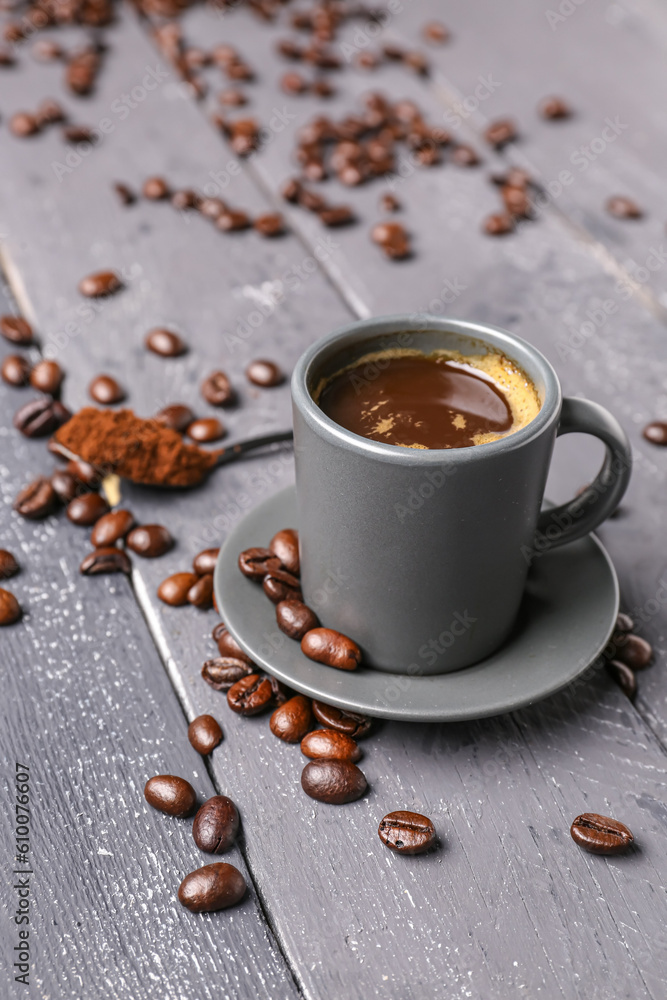 Cup of coffee, beans and spoon with powder on dark wooden background