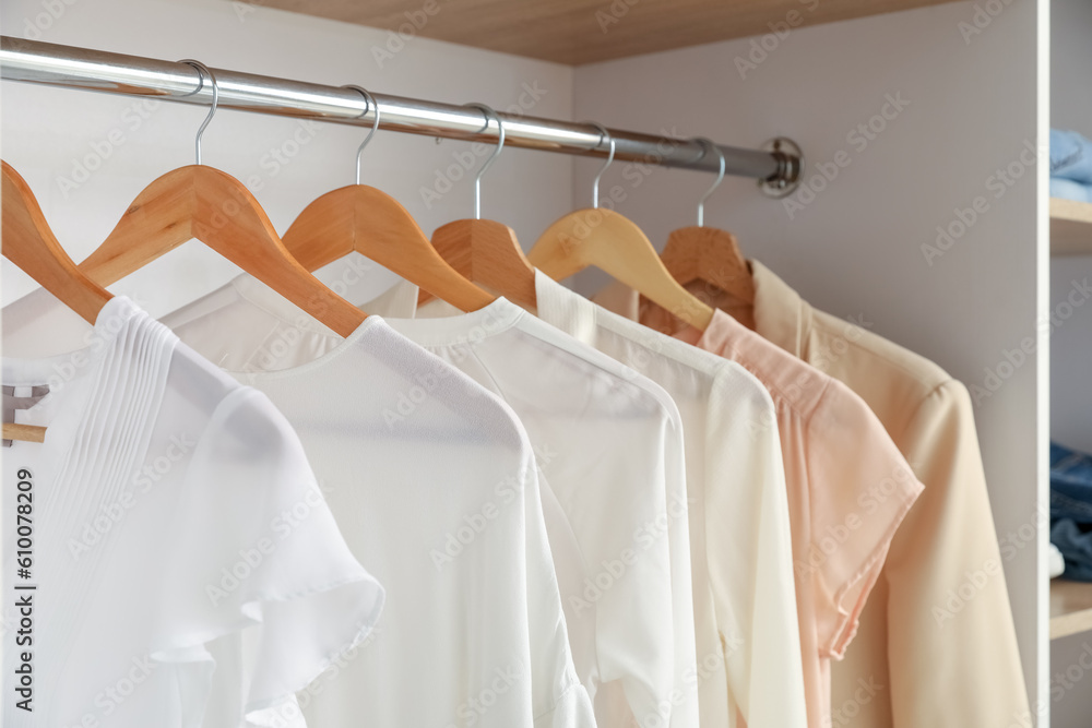 Stylish clothes hanging in boutique, closeup