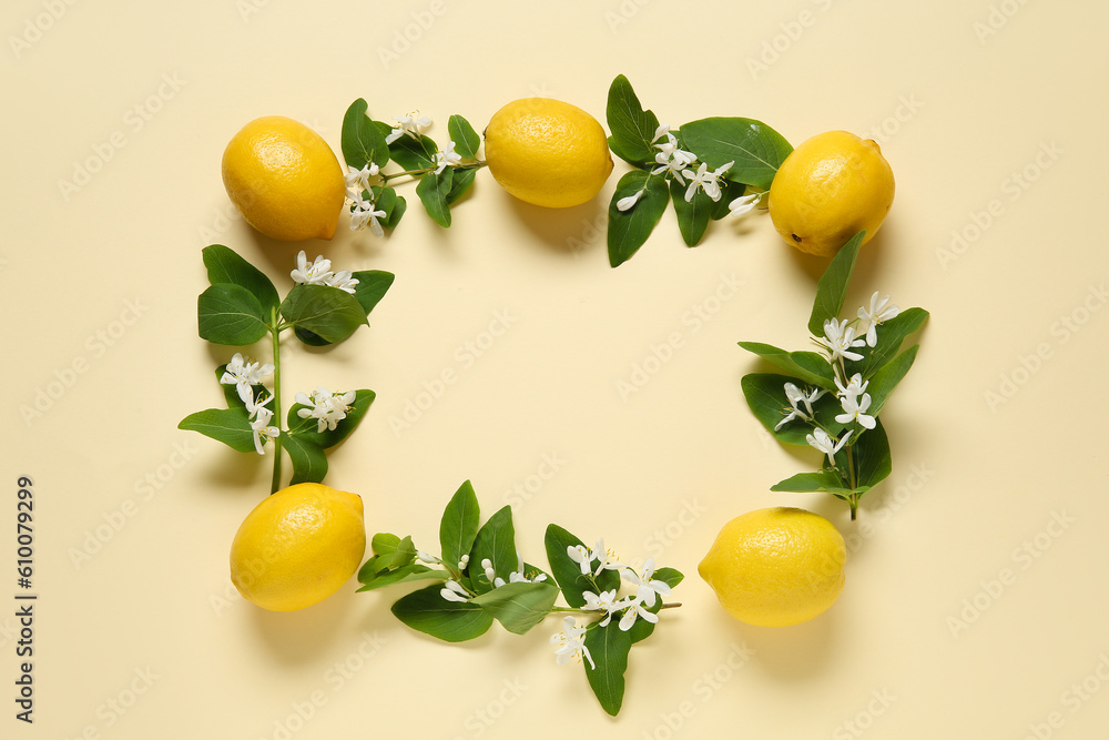 Frame made of lemons with blooming branches on beige background