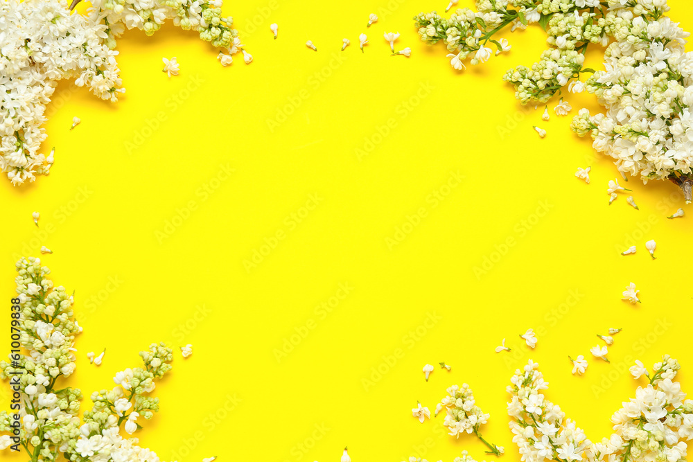 Frame made of white lilac twigs on yellow background