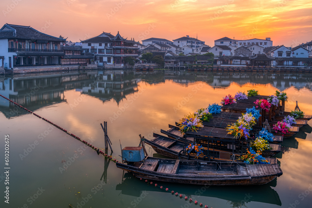 landscape with village, boats and wooden houses in sunrise