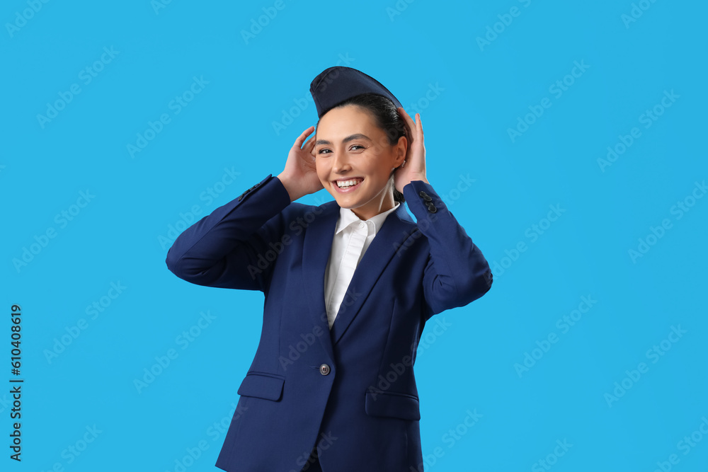 Beautiful stewardess on blue background