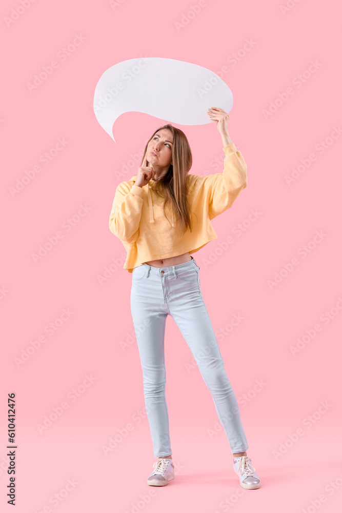 Thoughtful young woman with blank speech bubble on pink background