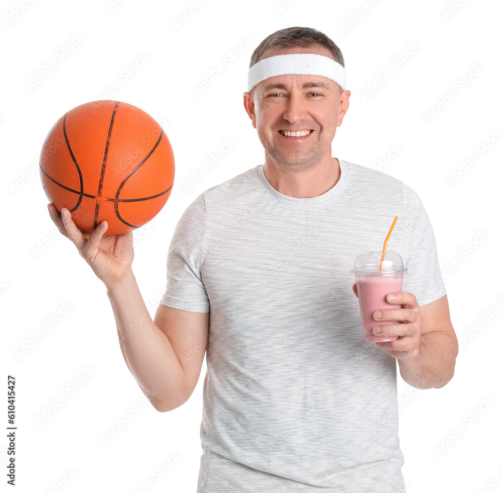 Sporty mature man with glass of fruit smoothie and ball on white background