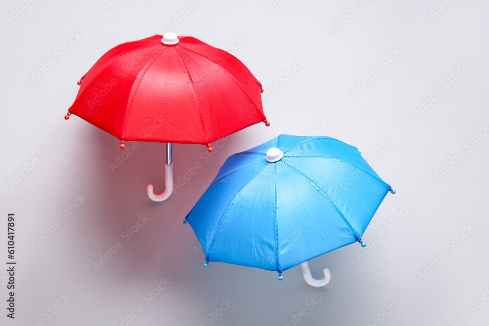 Mini umbrellas on white background