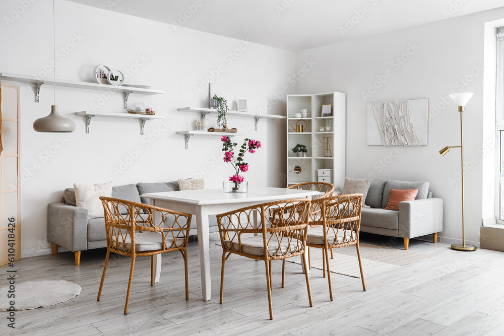 Interior of dining room with ikebana on table and shelves