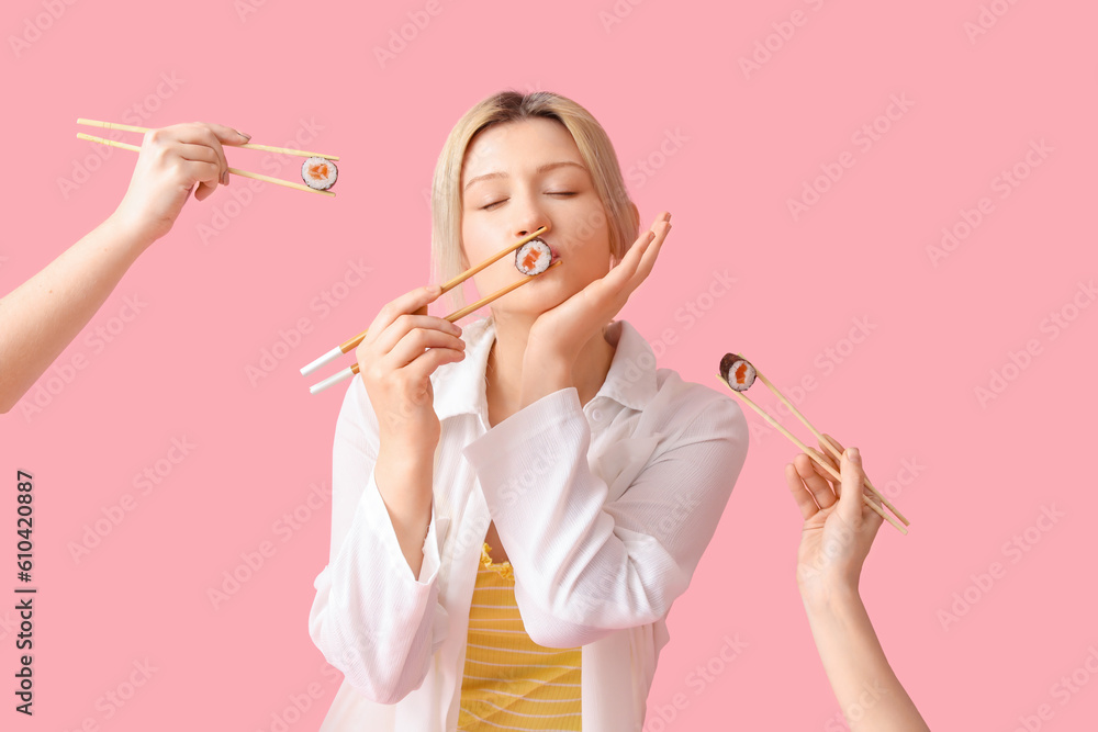 Young woman and female hands with sushi rolls on pink background