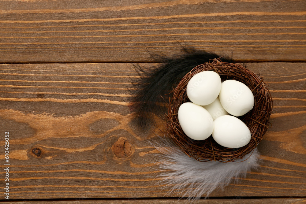 Nest of boiled quail eggs on wooden background