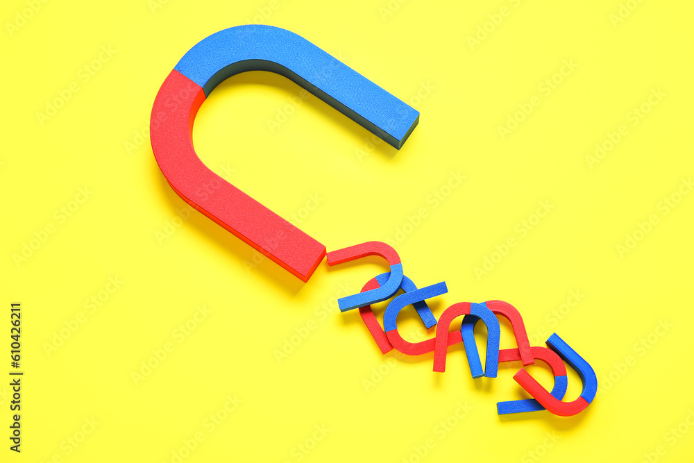 Horseshoe shaped magnets on yellow background