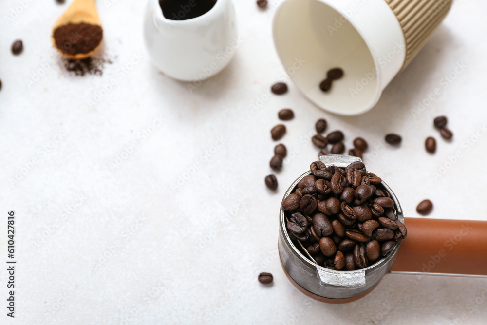 Portafilter with coffee beans on light background