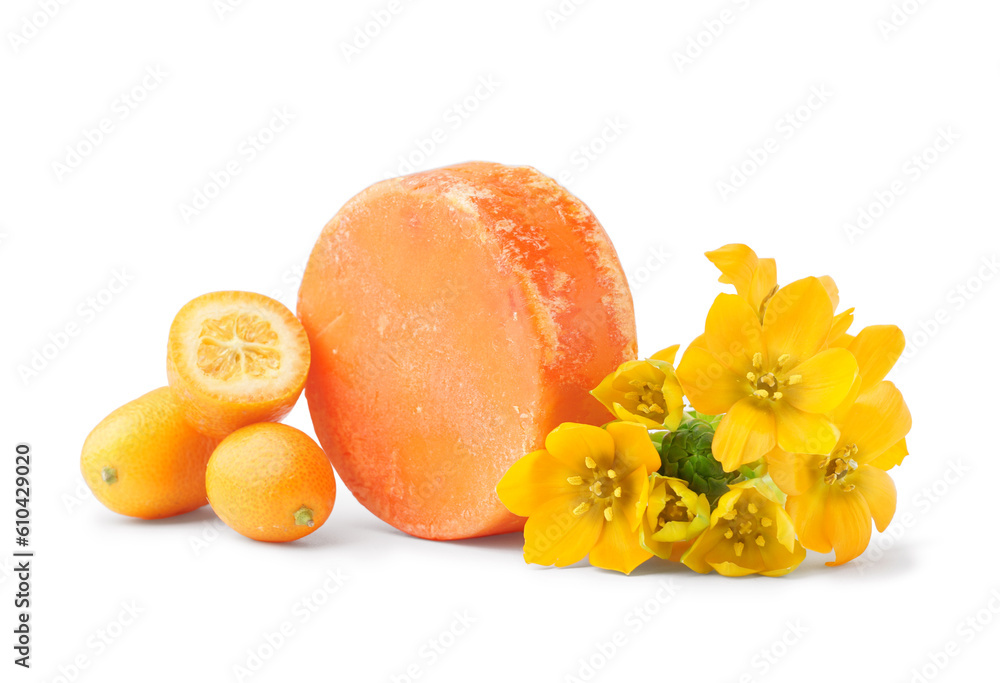 Orange solid shampoo bar with kumquat and flowers on white background