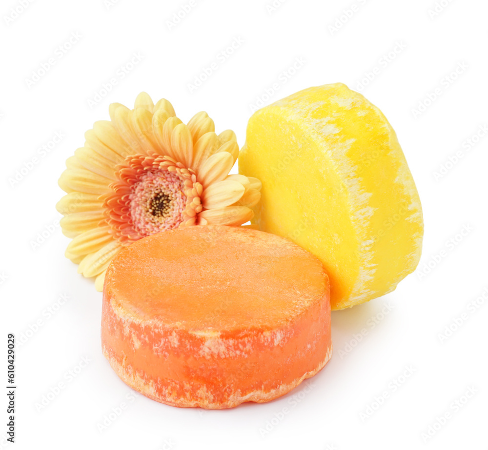 Solid shampoo bars with flower on white background