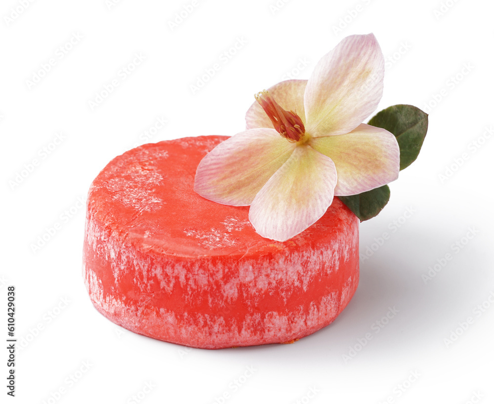 Red solid shampoo bar with flower on white background