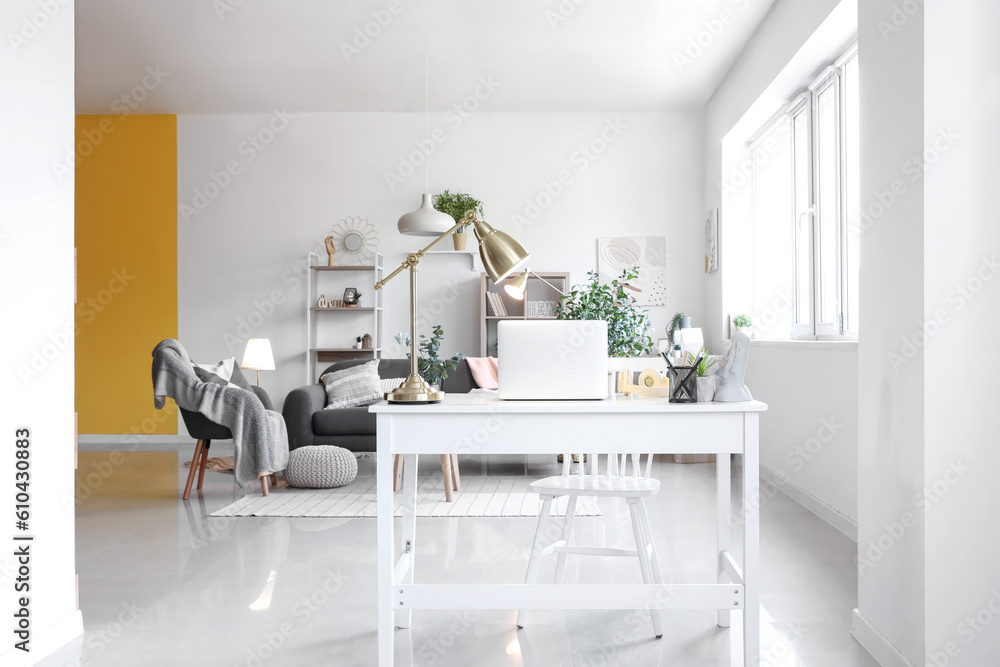 Interior of living room with workplace and glowing lamps