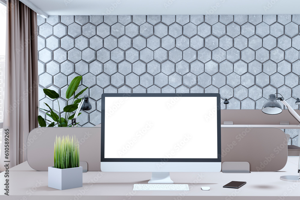 Creative designer office interior with decorative wall, empty white computer screen and other items.