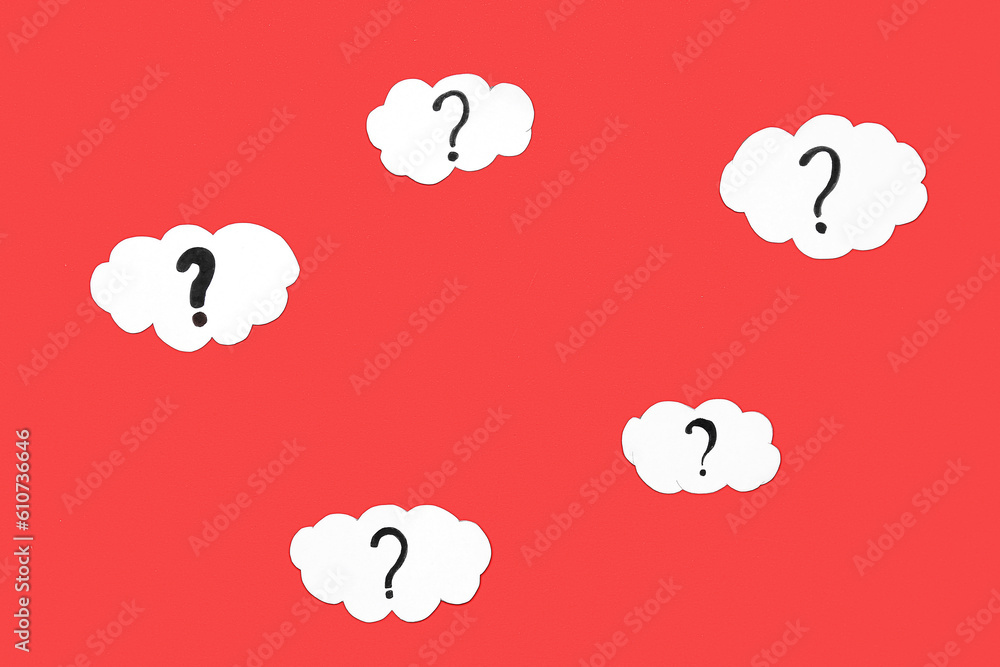 Frame made of paper clouds with question marks on red background