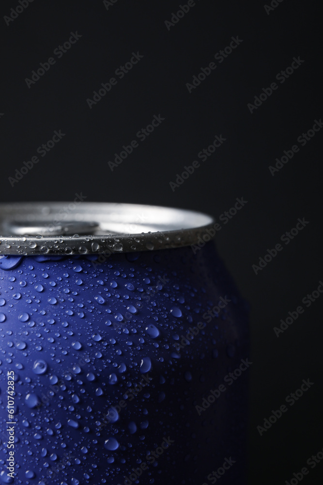 Lilac can of fresh soda with water drops on dark background, closeup