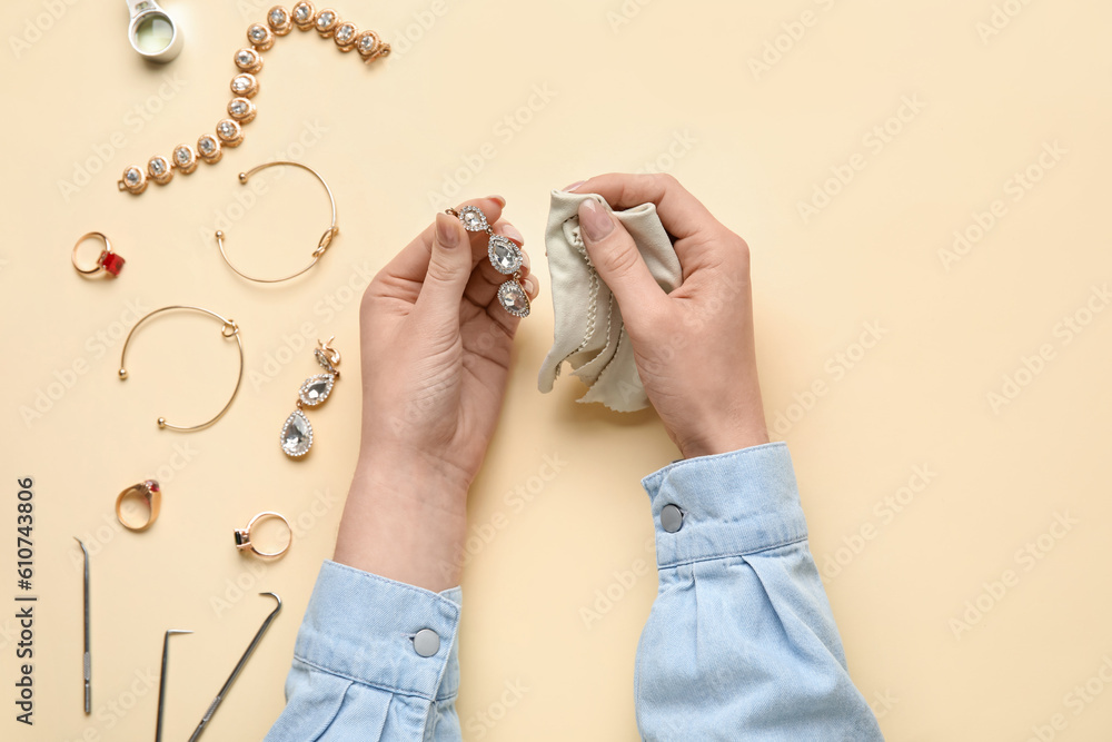 Woman cleaning different accessories on color background, closeup