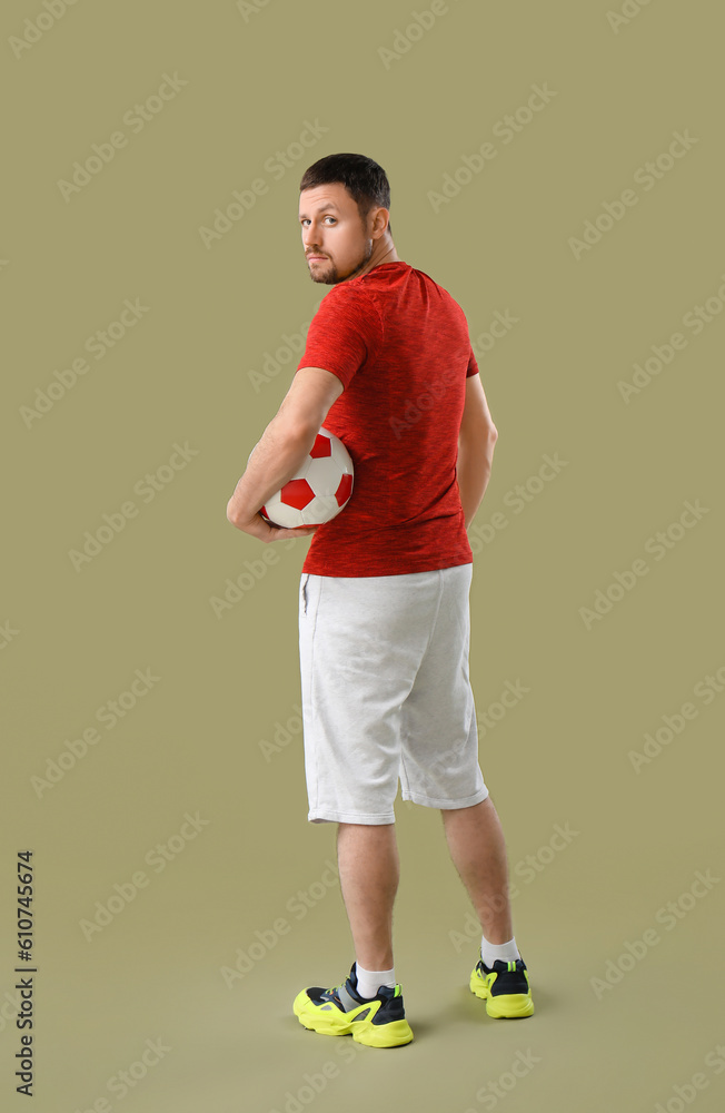 Man with soccer ball on color background