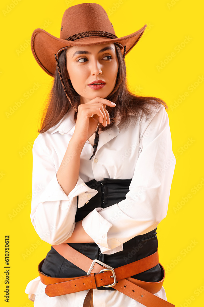 Beautiful cowgirl on yellow background