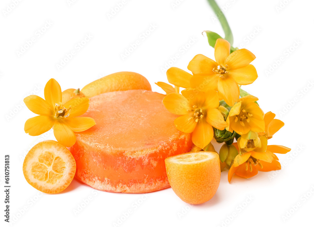 Orange solid shampoo bar with kumquat and flowers on white background