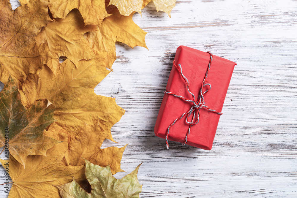 Bright autumn composition with gift box