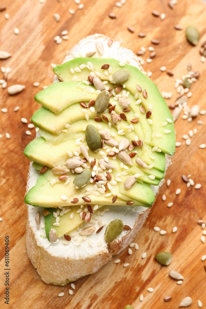 Tasty bruschetta with avocado on wooden background, closeup