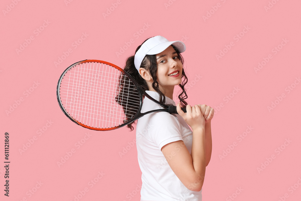 Teenage tennis player with racket on pink background