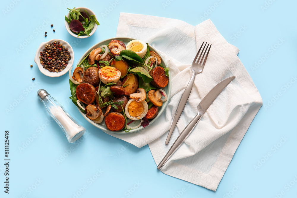 Composition with tasty potato salad on light blue background, top view