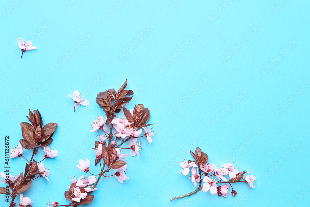 Blooming tree branches with pink flowers on blue background