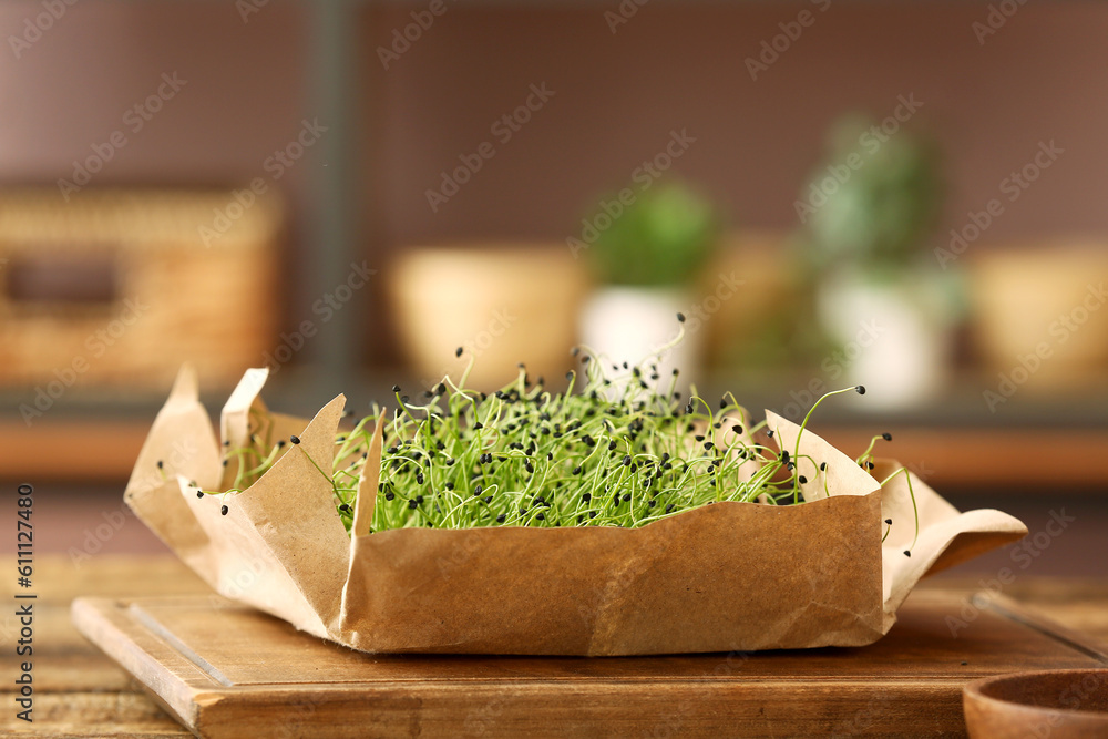 Wooden board with fresh micro green on table