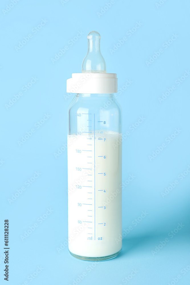 Bottle of milk for baby on blue background