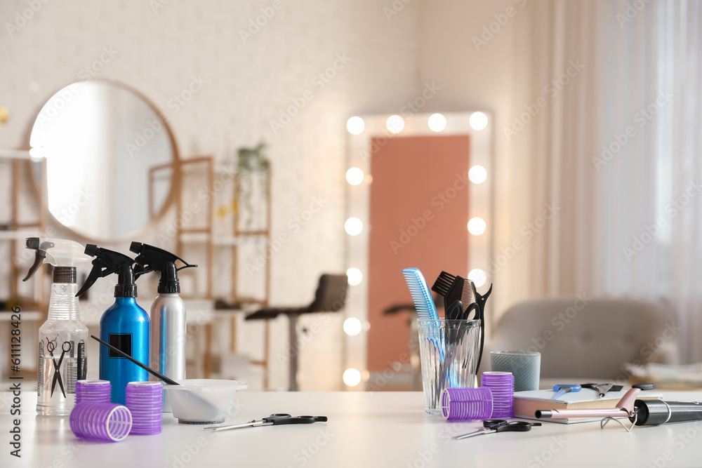 Different hairdressing tools on table in beauty salon