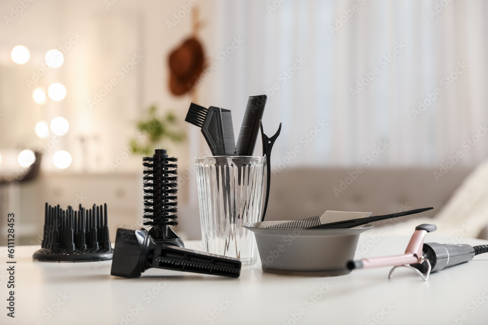 Different hairdressing tools on table in beauty salon