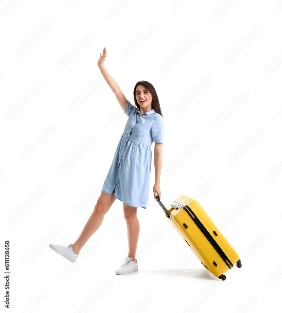 Happy young woman with yellow suitcase on white background