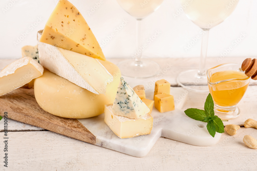 Board with different types of tasty cheese on table