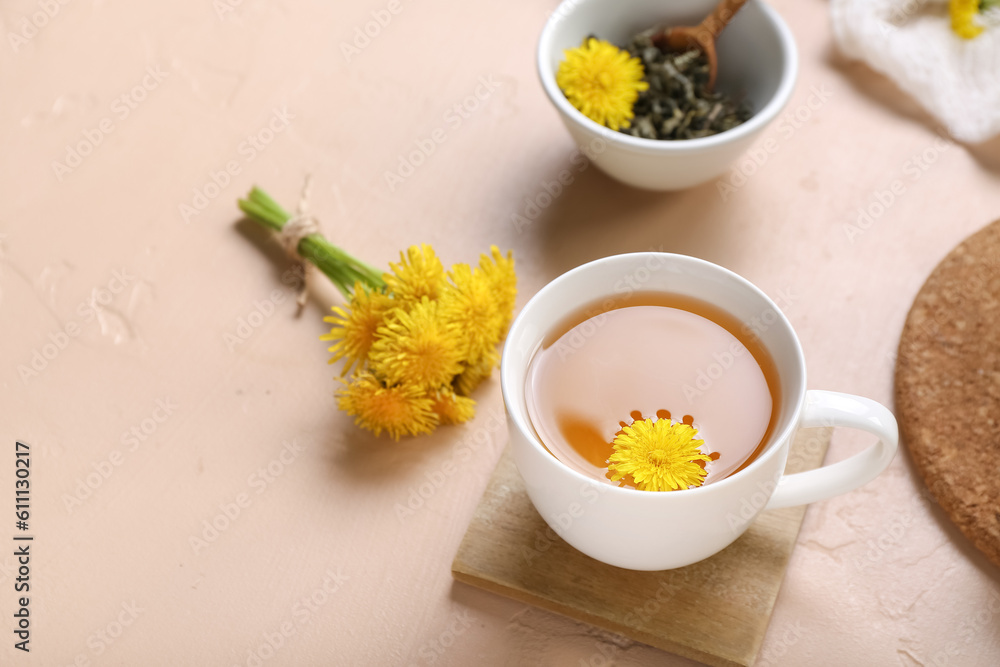 Cup of healthy dandelion tea on beige background