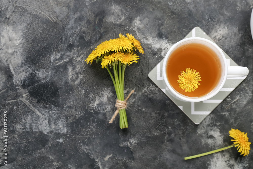 Cup of healthy dandelion tea on grey background