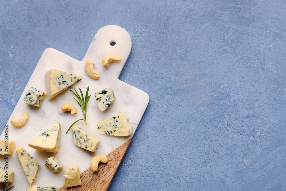 Board with pieces of tasty cheese on grey background