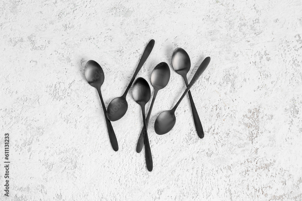 Stainless steel spoons on white background