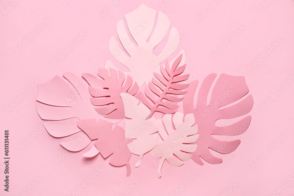 Different paper tropical leaves on pale pink background