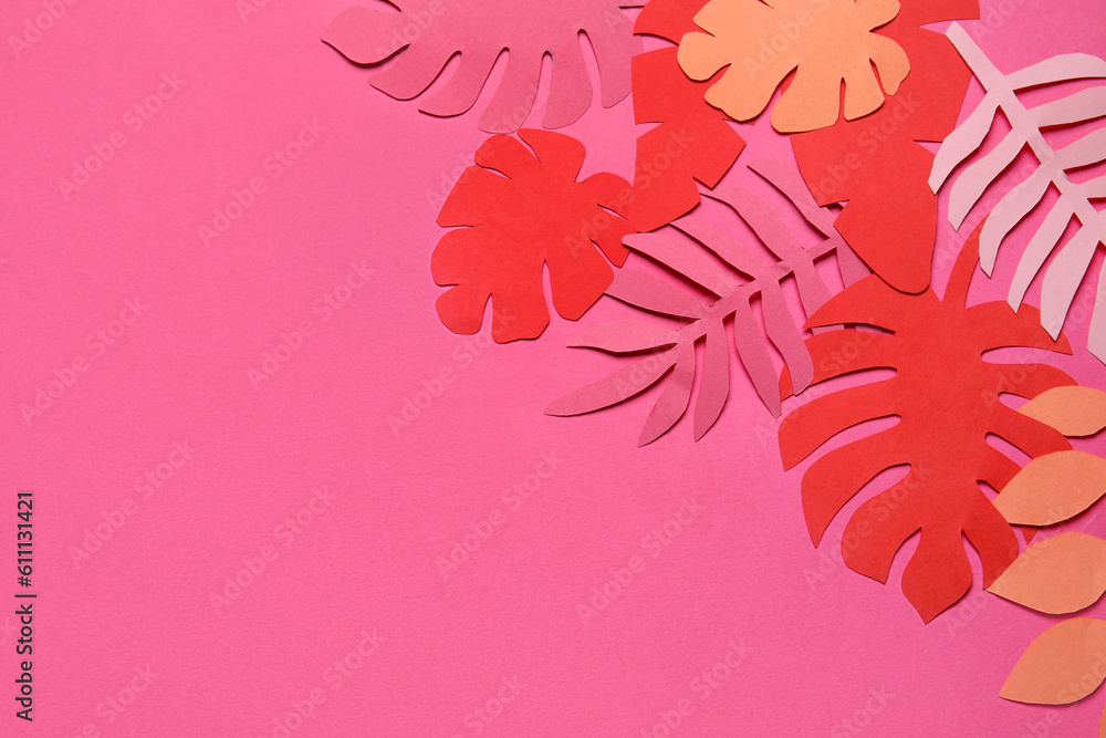 Different paper tropical leaves on pink background