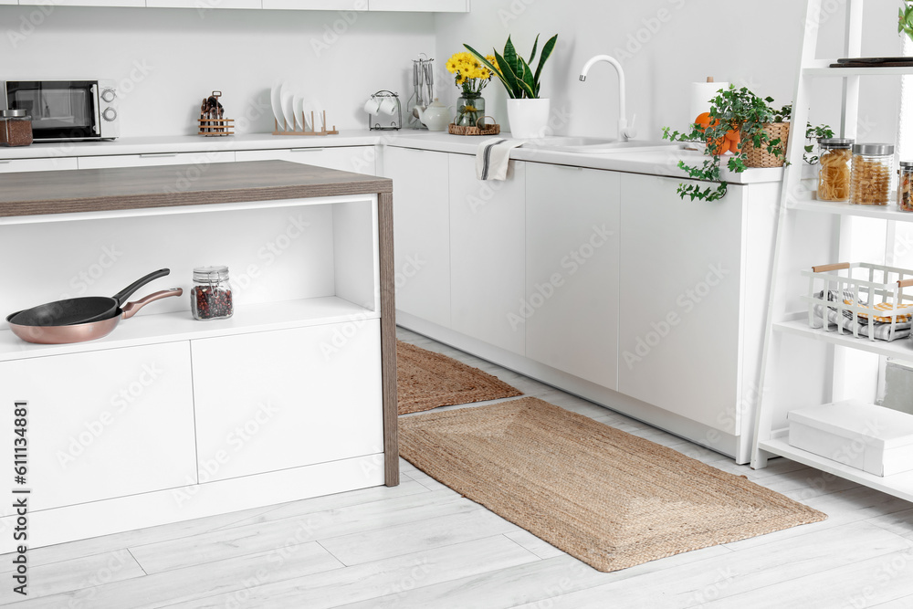 Wicker rug on floor in light kitchen