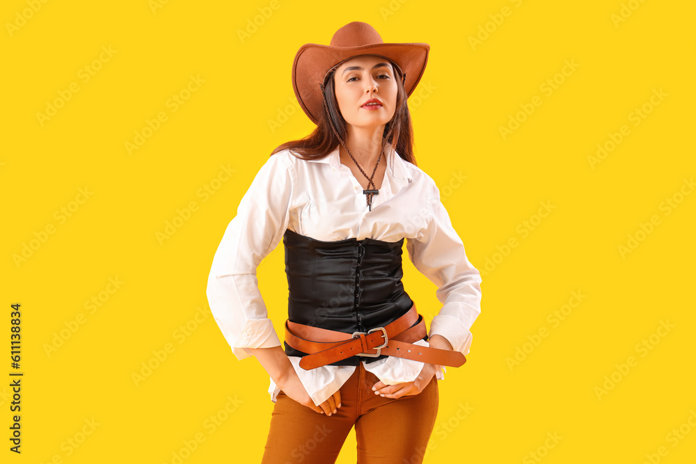 Beautiful cowgirl on yellow background