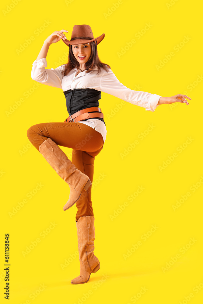 Beautiful cowgirl on yellow background